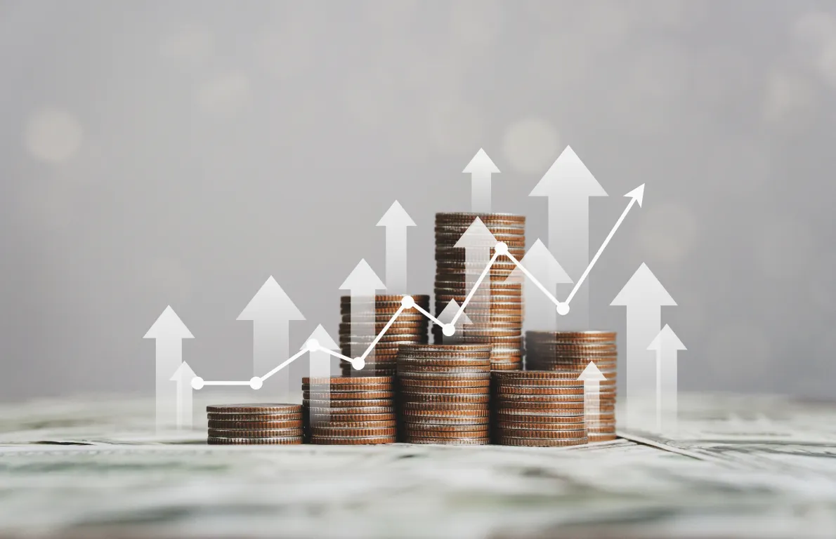 Stacked coins with growth arrows representing investment management